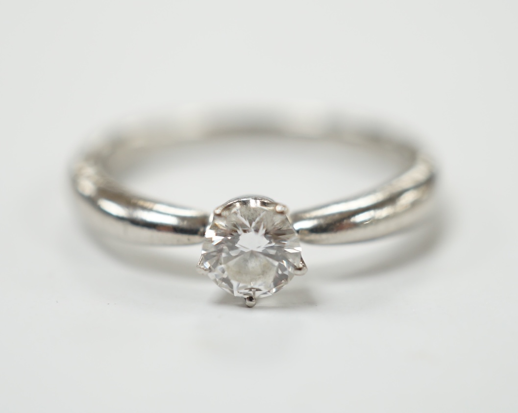 A modern white metal (stamped PT950) and solitaire diamond set ring, size H/I, gross weight 3.8 grams. Good condition.